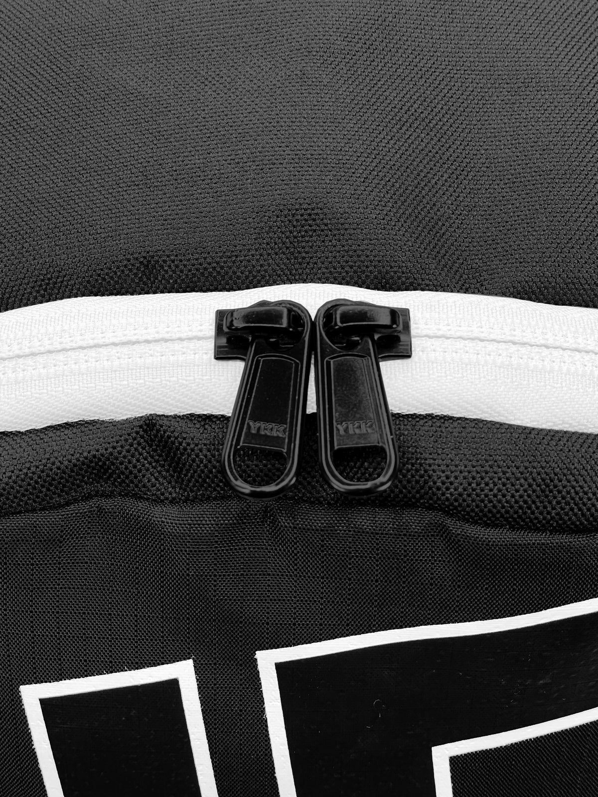 Side view of black Active Mini Backpack showing dual water bottle holders