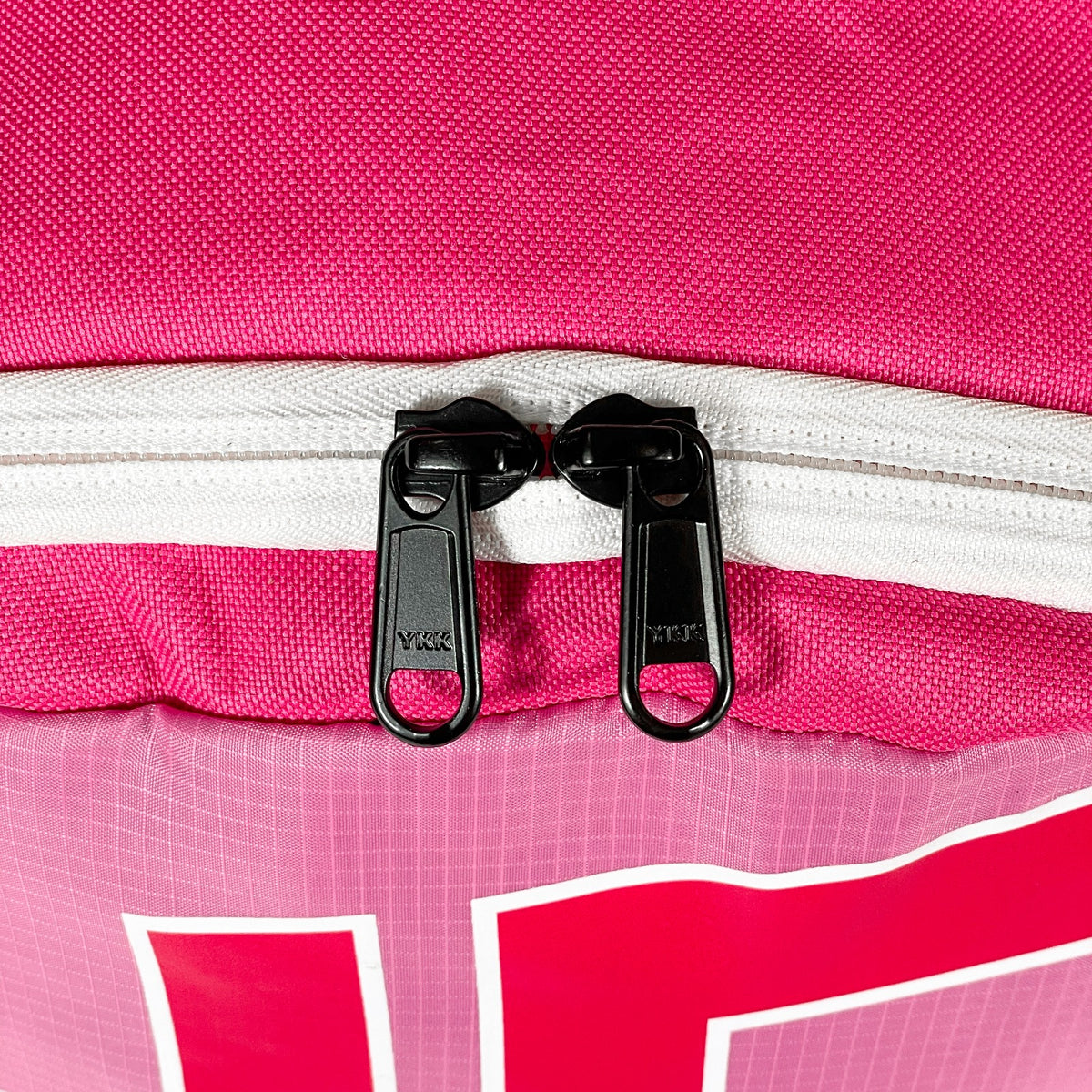 Compact pink backpack by Hustlers Only with front zippered pocket and lightweight design
