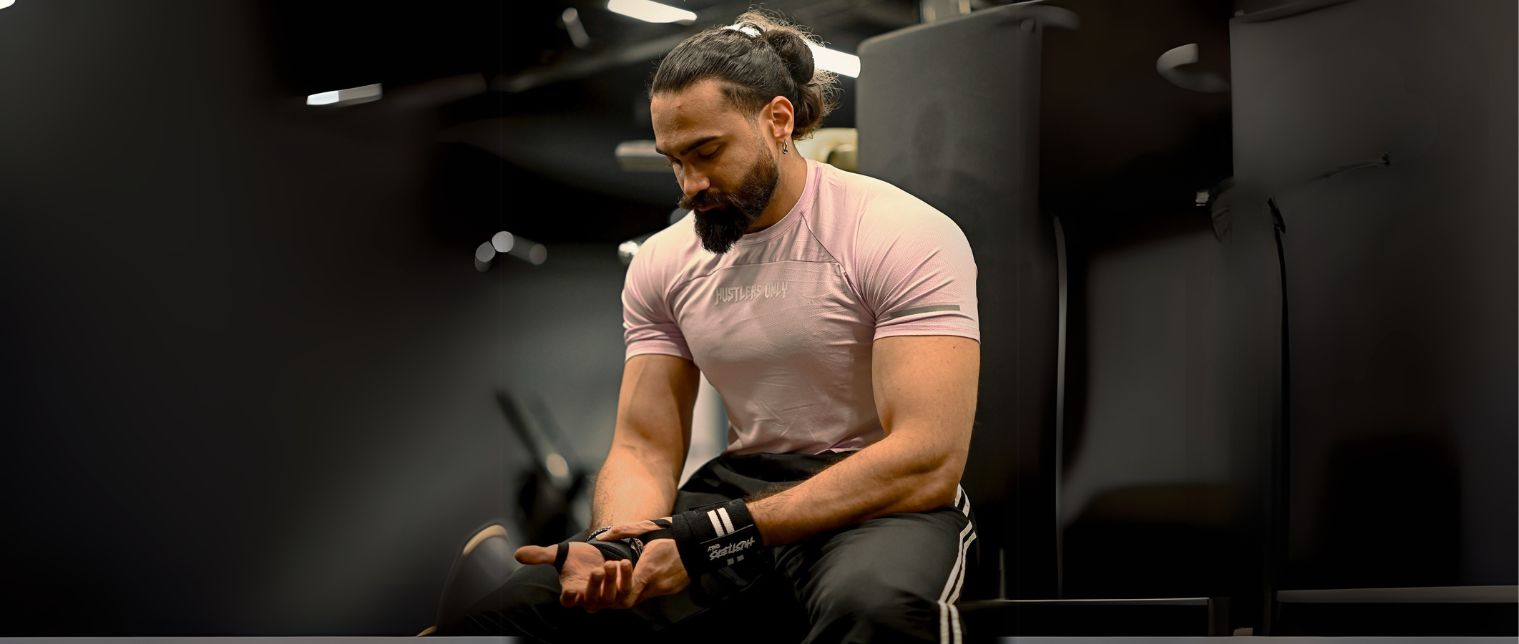 Man Sitting on a Bench in the Gym Wearing Perfect Gym T-shirt | Hustlers Only PK